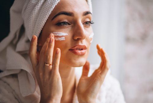 Woman applying face cream